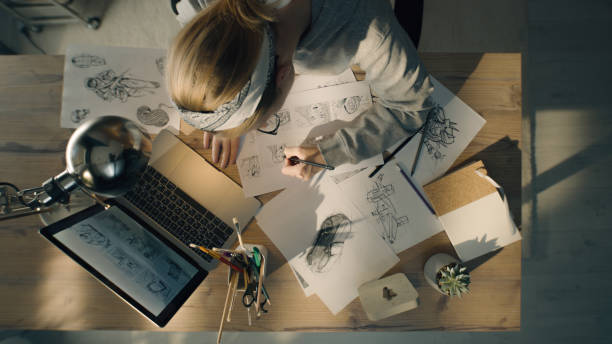 Young woman works on a storyboard in a design studio draws sketch for the videos stock photo
