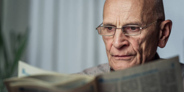 istock Grandpa wearing eyeglasses enjoying while reading newspaper 1431069002