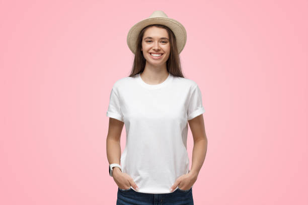 relaxed smiling girl in summer hat isolated on pink background