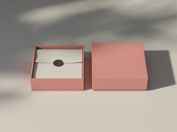 istock Pink coral Box Mockup with white wrapping paper and sticker on white table with shadows 1431072732