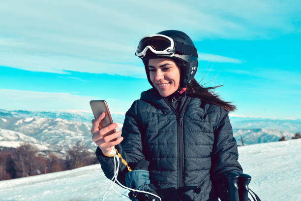 istock Happy Female Taking Selfie While Skiing On Mountain 1431073893