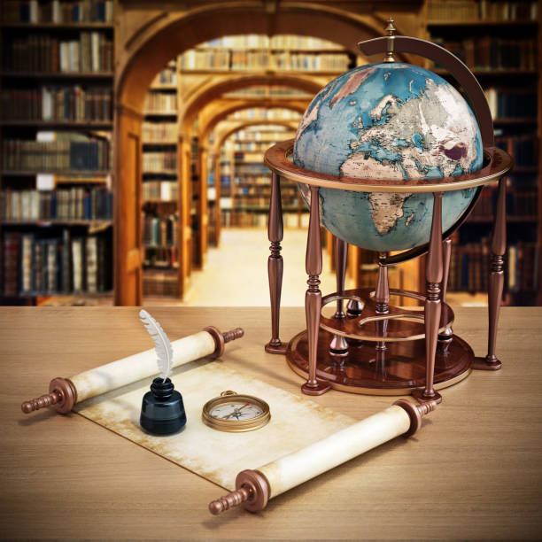 istock Antique globe, empty parchment, compass and quill standing on the table with library shelves on the background 1431075258