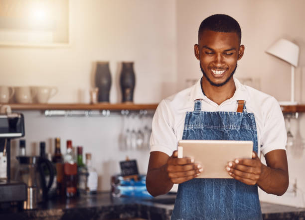 istock Management, planning and stock with happy restaurant manager checking inventory on digital tablet. Proud employee feeling successful while doing online task, reading, using app to target budget cuts 1431076117