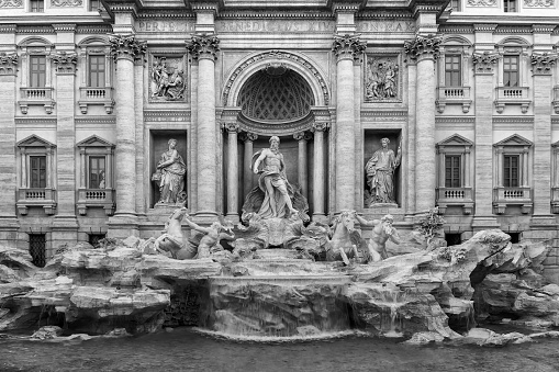 The famous Trevi fountain seen from the front. daylight photography with natural light, long exposure to highlight the movement of the water falls.