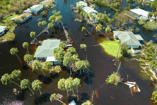 Hurricane Ian flooded houses in Florida residential area. Natural disaster and its consequences.