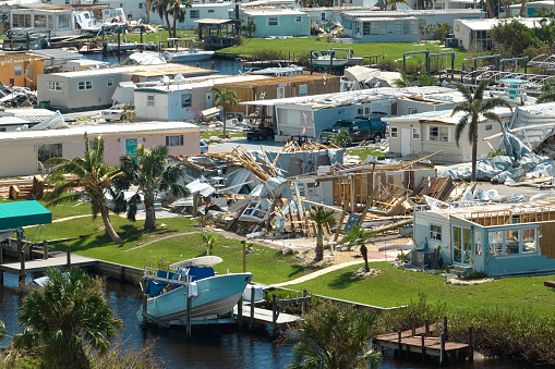 Hurricane Ian destroyed homes in Florida residential area. Natural disaster and its consequences.
