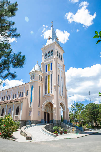 istock Cathedral of Dalat diocese on blue sky background, hidden behind pine tree branches on sunny day with left view, located in Lam Dong province, Vietnam 1431082871
