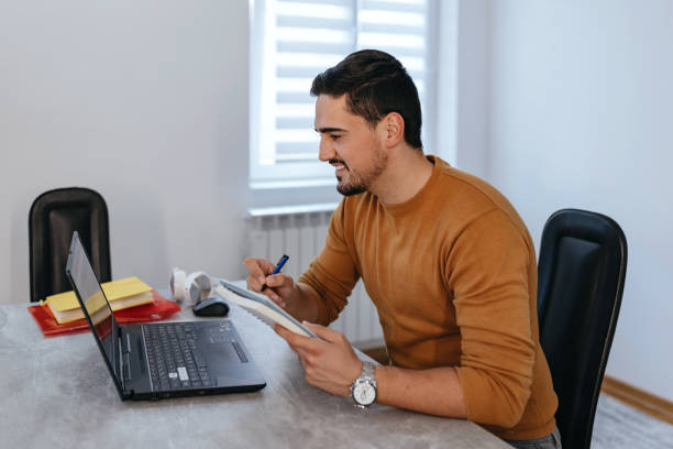 istock Happy handsome guy chilling at home, surfing the net 1431084534