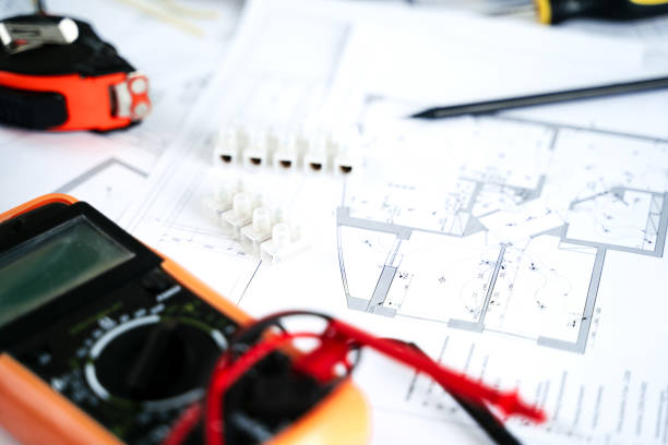 istock Making repairs,planning electricity project in house.Drawings,diagrams,plan for electrification of apartment, building. Devices and accessories, voltmeter, wires, screwdriver, pliers and tape measure 1431085553