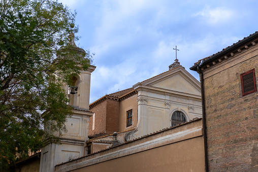 Side View with the Bell Tower of the Basilica of San Clemente in the Center of Rome on a Background of Partly Cloudy Sky