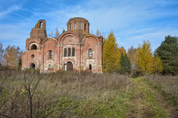 Photo of abandoned red brick Christian church in depths of Russia, abandoned building in wilderness