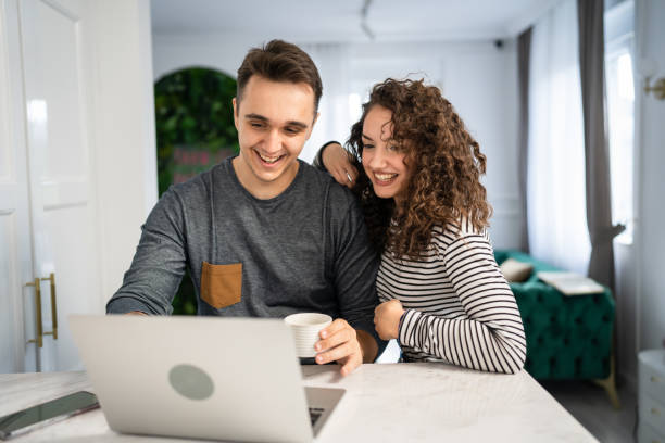 istock happy couple using laptop computer with cup of coffee morning routine 1431095373