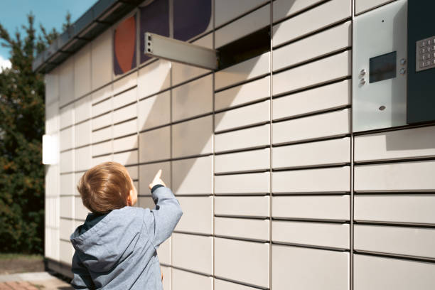 istock Pickup parcel. Child showing open door box at post delivery automat terminal. Self service post terminal and parcel delivery concept 1431098059