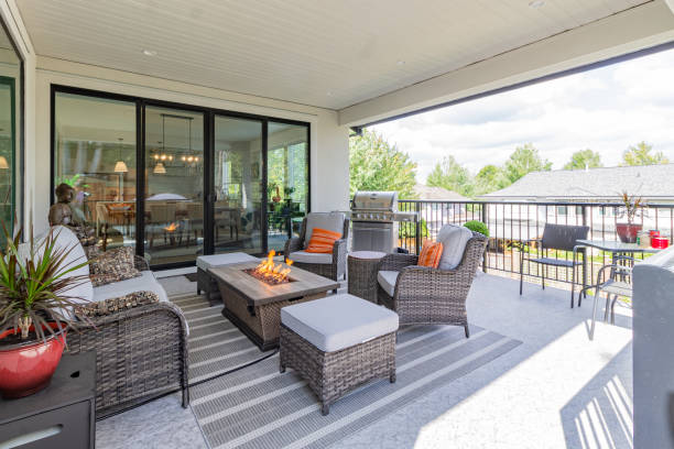 A luxurious deck with stylish patio furniture A spacious deck with a fire pit table heater and a BBQ grill sliding door stock pictures, royalty-free photos & images