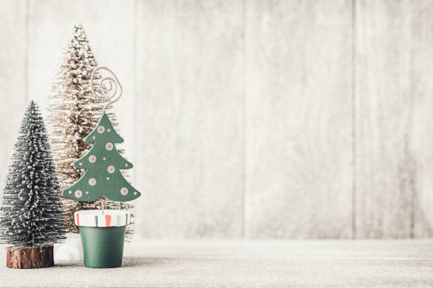 istock Artificial Christmas tree on a wooden background. 1431100352