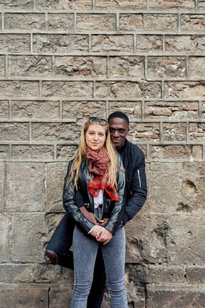 istock Smiling couple embracing in the street. 1431101564