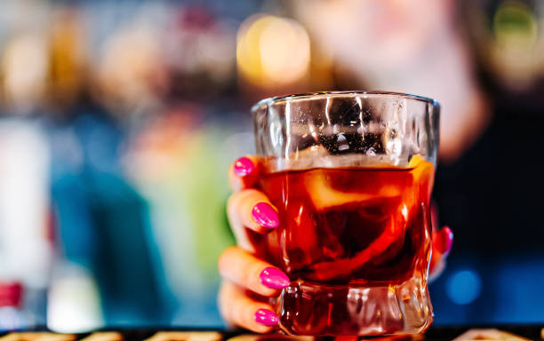 istock woman hand bartender making negroni cocktail in bar 1431103612