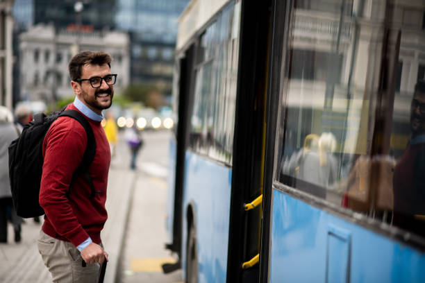 istock Attractive young businessman getting on a bus 1431104272