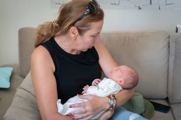 istock Mother holding her sleeping baby 1431108202