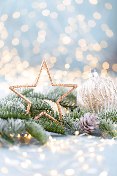 Christmas spruce with star and blurred shiny lights.