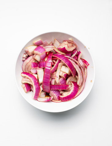 Red Onion in a Bowl of Vinegar and Soy Sauce - Studio lit - Chopped\nCanon R5\n\nIngredient for Bibimbap (Korean Rice Bowl)\nServed as a bowl of warm white rice and beef topped with red onions, carrots, mushrooms, zucchini, and scallions.