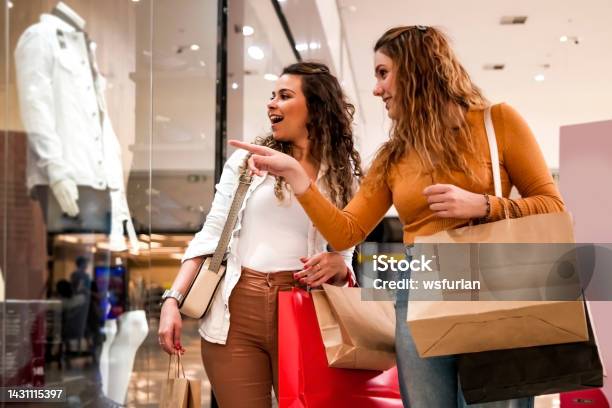 Two Women Making Shopping Stock Photo - Download Image Now - Shopping Mall, Shopping, Retail