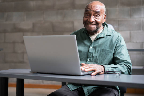 istock Portrait of mature black computing  student typing on a laptop at a technology class for seniors 1431116661