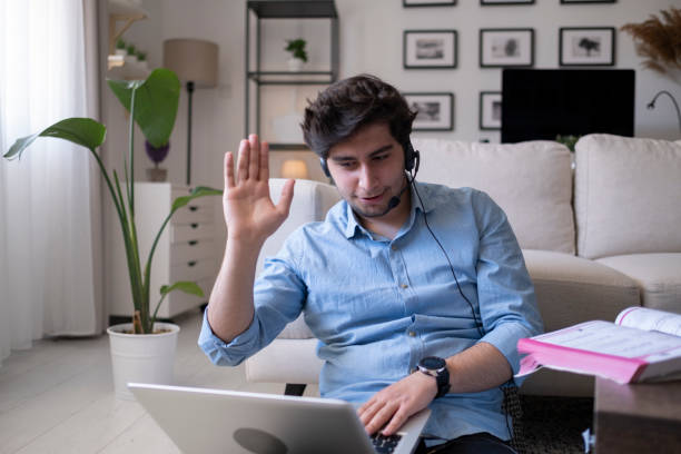 istock Smiling guy in headphones looking at laptop 1431117566