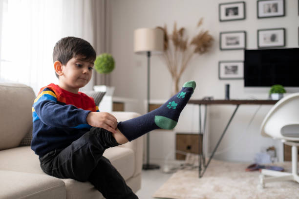 istock Adorable little boy trying to put a socks. 1431118920