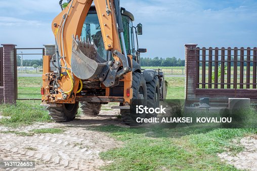 istock Excavator bucket close-up on the background of a construction site. Heavy earthmoving equipment. Soil development 1431126653