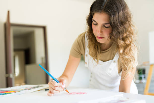 istock Focused caucasian woman doing a painting 1431127068