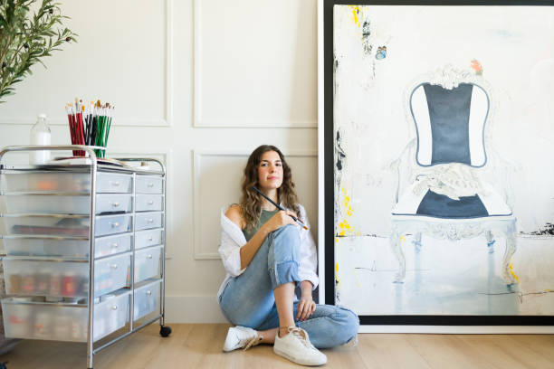 istock Talented woman painter posing with her new painting 1431127212