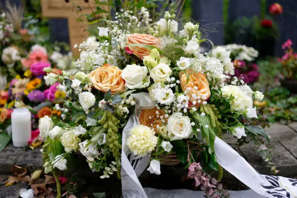 Photo of pastel funeral flowers on a grave