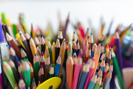 a pile of unsorted school supplies in a bin