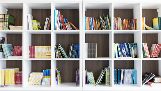 Stack of  books on the table of public library.