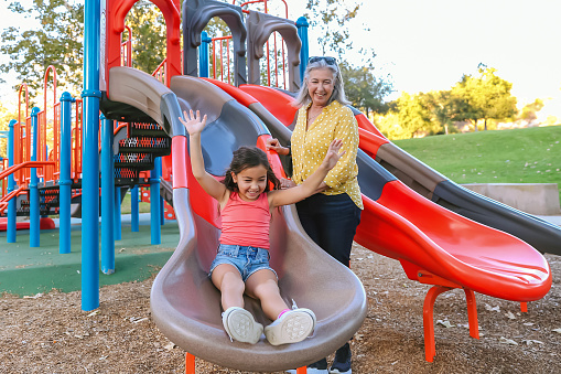 Grandma and granddaughter playing at a park