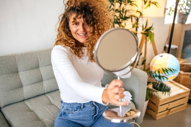 istock Woman styles her hair 1431148924
