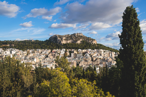 Athens, Attica, beautiful super-wide summer angle view of Athens, Greece, with Acropolis, Mount Lycabettus, mountains and scenery beyond the city, seen from Strefi Hill in Exarcheia neighbourhood