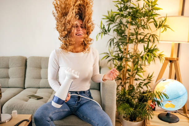 istock Woman is blowing dry hair 1431149397