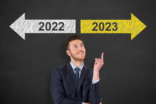 Old Year or New Year 2023 Over Human Head on Blackboard Background