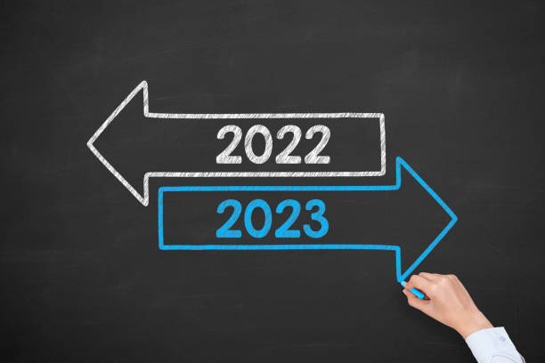 istock Human Hand Drawing Old Year or New Year 2023 on Blackboard Background 1431150277