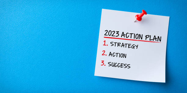 istock White Sticky Note With New Year 2023 Action Plan And Red Push Pin On Blue Cardboard Background 1431150397