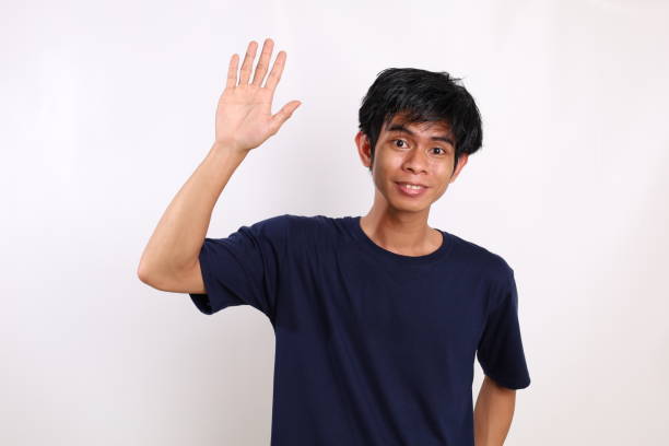 istock Happy asian young man standing while showing hello gesture or five fingers. Isolated on white background 1431150941