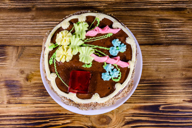 istock Kiev cake with cream, nuts and meringue on a wooden table. Top view 1431150959