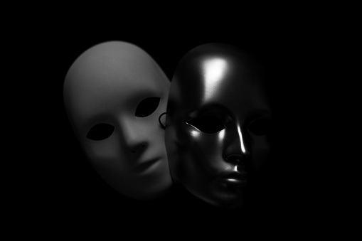 Face masks in black and white with black background.