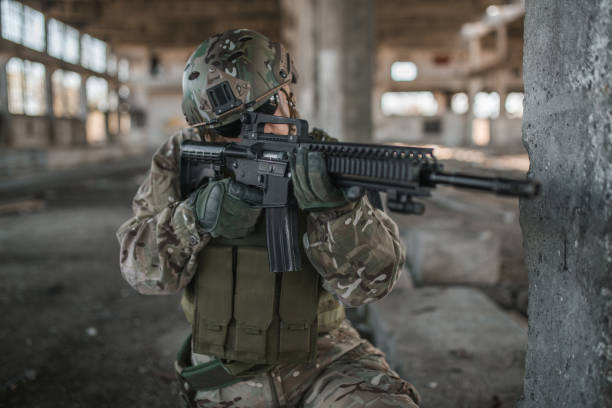 istock Focused female army soldier with rifle aiming at target 1431171630