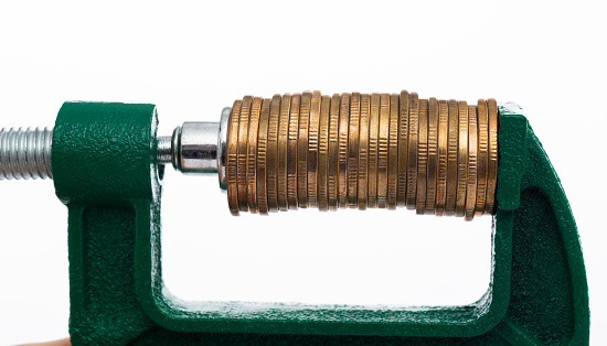 Green clamp with stack of coins.