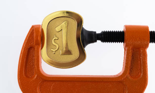 C-clamp bending a dollar coin.