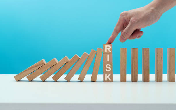 istock Man hand stopping the dominos falling 1431187914