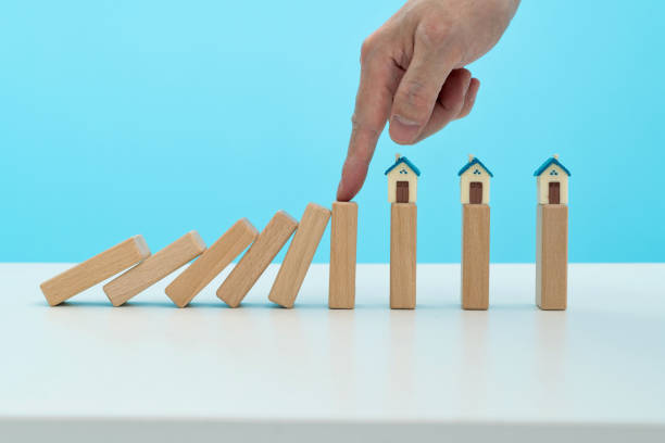 istock Man hand stop dominoes from falling on the house 1431188012